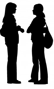 Silhouette of two women talking to each other
